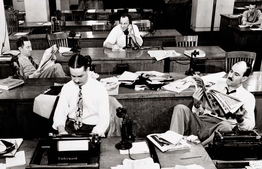 New York, New York. Newsroom of the New York Times newspaper. Reporters and rewrite men writing stories, and waiting to be sent out. Rewrite man in background gets the story on the phone from reporter outside. 1942 Sept. Collins, Marjory, 1912-1985, photographer. Library of Congres, LC-USW3- 009017-D [P&P] LOT 242