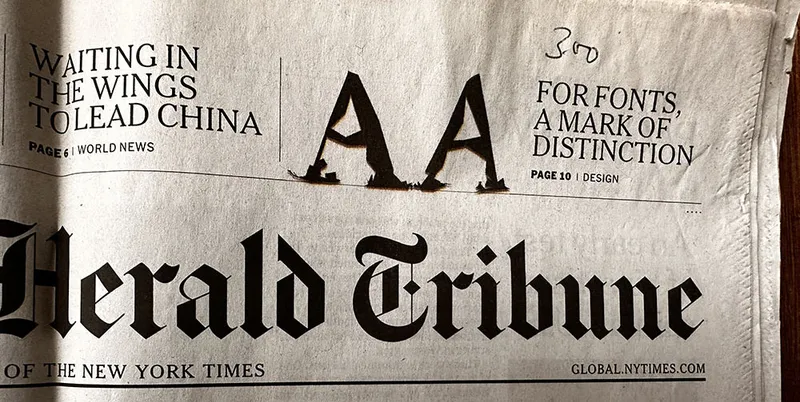 Photo of the cover of the International Herald Tribune, January 24, 2011. Part of the masthead is visible. Two A's from LTR Beowolf in the top right.